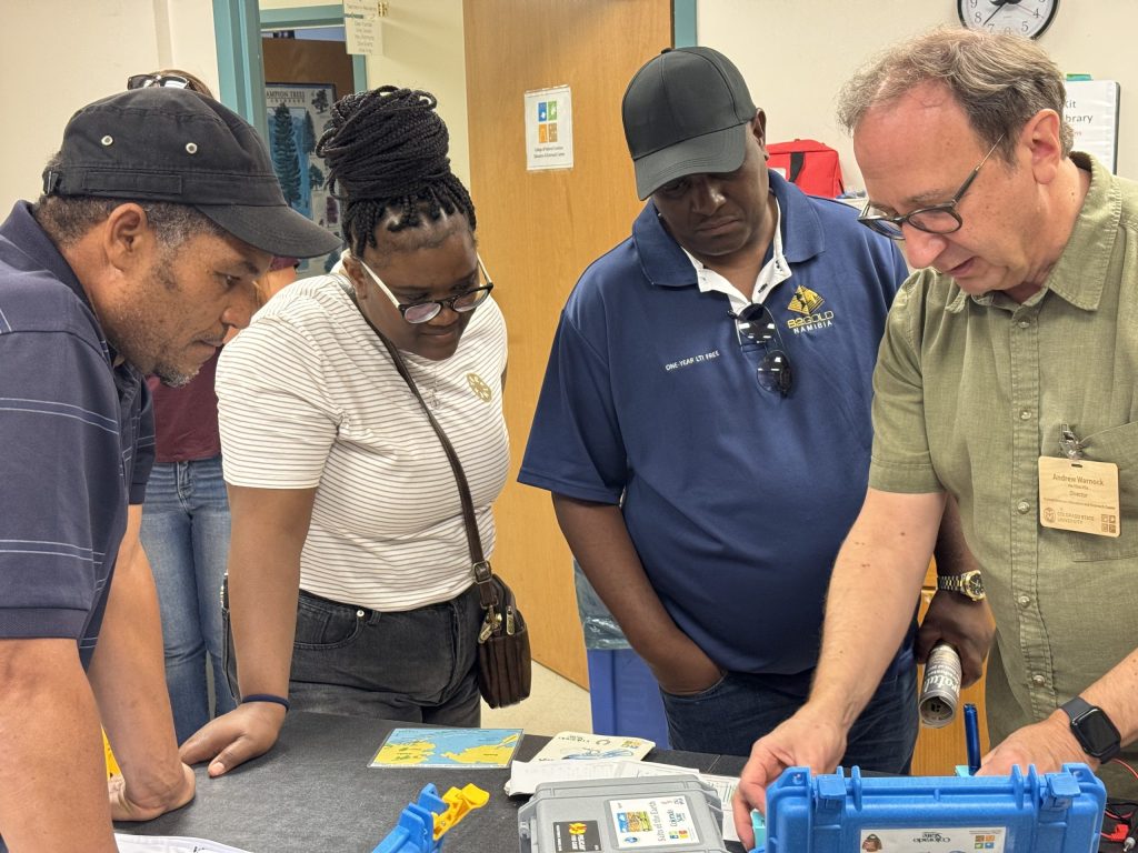 namibians-1 Folks standing around looking at experiments on a desk