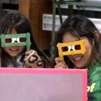Student and intern looking through colored glasses
